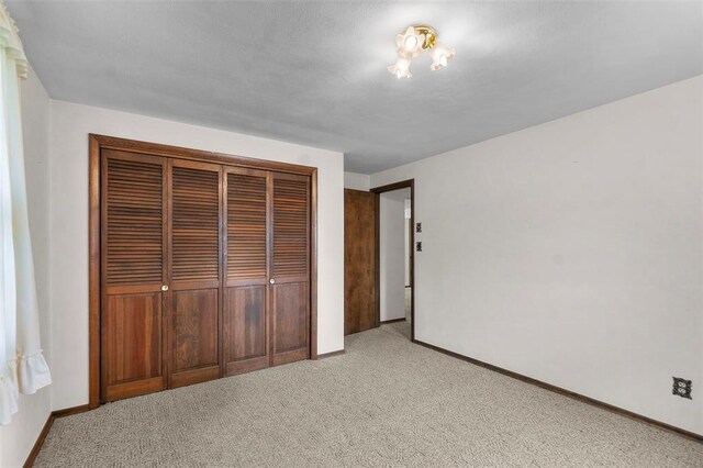 626 Sue Dr, Jackson, MO 63755 - unfurnished bedroom with light carpet, a closet, and baseboards