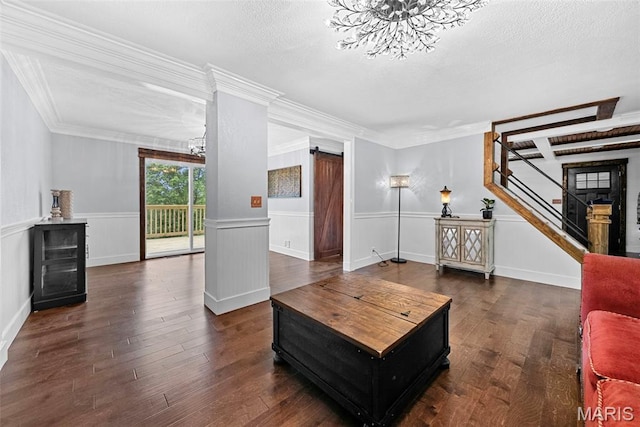 425 Cedar Ln, Wentzville, MO 63385 - living area with a chandelier, stairway, a wainscoted wall, wood finished floors, and a textured ceiling