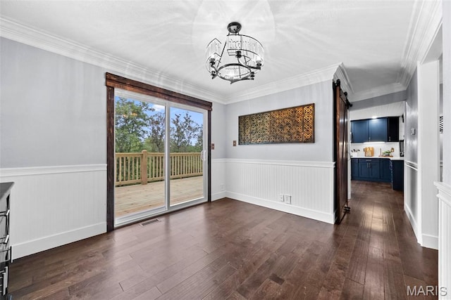 425 Cedar Ln, Wentzville, MO 63385 - unfurnished dining area featuring a chandelier, dark wood-style floors, a wainscoted wall, a barn door, and crown molding