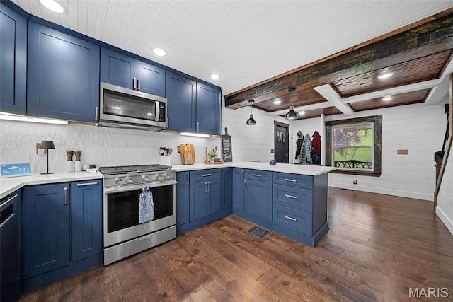 425 Cedar Ln, Wentzville, MO 63385 - kitchen featuring appliances with stainless steel finishes, blue cabinets, a peninsula, light countertops, and wood ceiling with exposed beams