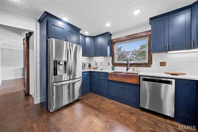 425 Cedar Ln, Wentzville, MO 63385 - kitchen featuring appliances with stainless steel finishes, blue cabinetry, light countertops, a sink, and recessed lighting