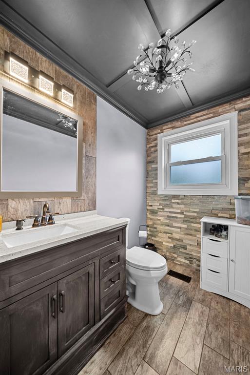 425 Cedar Ln, Wentzville, MO 63385 - bathroom featuring vanity, a chandelier, wood finished floors, and toilet