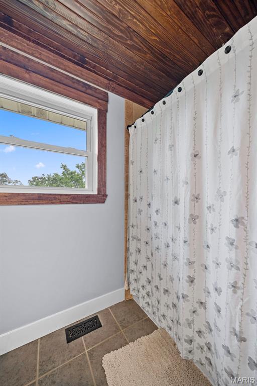 425 Cedar Ln, Wentzville, MO 63385 - bathroom featuring baseboards, tile patterned flooring, wood ceiling, and a shower with curtain