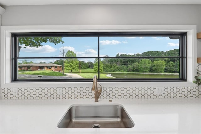 527 W Lake Dr, Edwardsville, IL 62025 - kitchen view of a sink, light countertops, and backsplash
