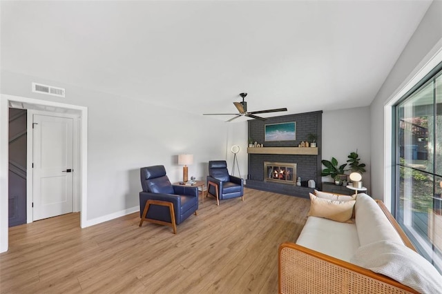 527 W Lake Dr, Edwardsville, IL 62025 - living area featuring ceiling fan, light wood finished floors, a fireplace, and baseboards