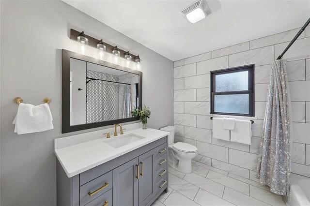 527 W Lake Dr, Edwardsville, IL 62025 - bathroom with marble look tile flooring, vanity, curtained shower, and toilet