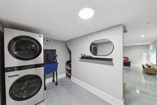 527 W Lake Dr, Edwardsville, IL 62025 - laundry area featuring stacked washing machine and dryer, baseboards, and recessed lighting