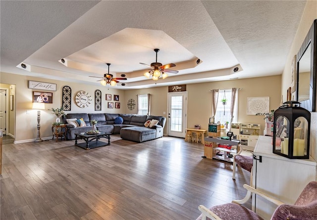 1114 Daffodil St, Sikeston, MO 63801 - living room with a raised ceiling, wood finished floors, a textured ceiling, and ceiling fan