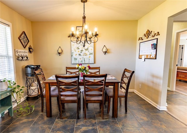 1114 Daffodil St, Sikeston, MO 63801 - dining space featuring a chandelier, stone finish floors, and baseboards
