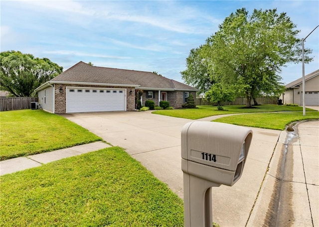 1114 Daffodil St, Sikeston, MO 63801 - view of front of property featuring brick siding, concrete driveway, an attached garage, and central AC