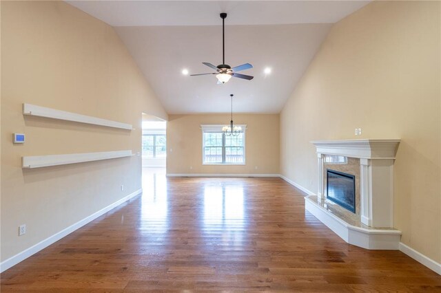 924 Brookside Ln, Rolla, MO 65401 - unfurnished living room with a ceiling fan, wood finished floors, a premium fireplace, a chandelier, and high vaulted ceiling