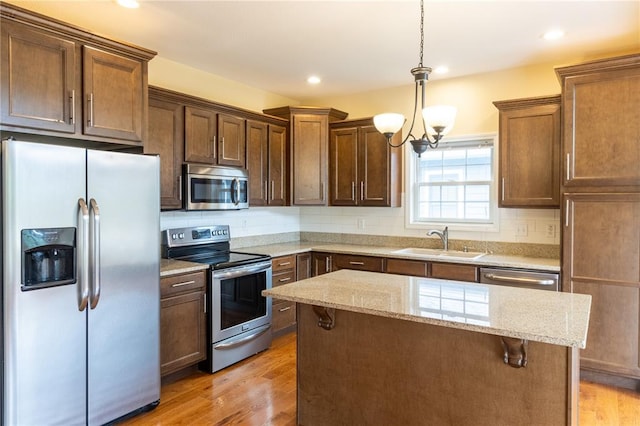 924 Brookside Ln, Rolla, MO 65401 - kitchen with appliances with stainless steel finishes, a sink, light wood-style floors, light stone counters, and recessed lighting