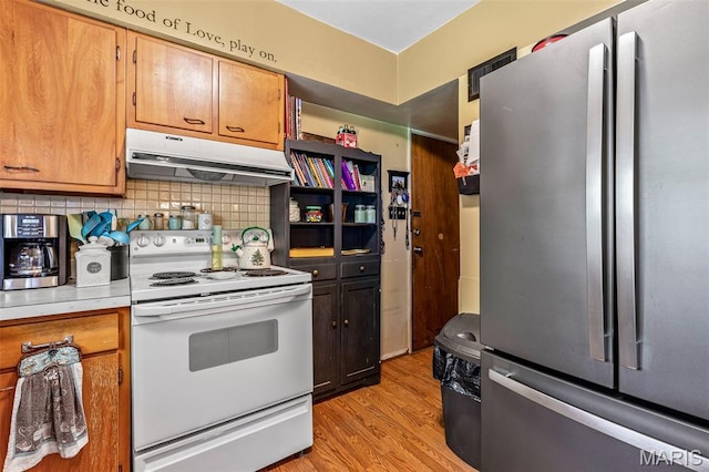5 Heathwood Ln, Fenton, MO 63026 - kitchen with freestanding refrigerator, under cabinet range hood, white range with electric cooktop, light wood-style floors, and light countertops