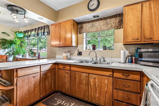 5 Heathwood Ln, Fenton, MO 63026 - kitchen featuring a peninsula, light countertops, stainless steel microwave, and brown cabinetry