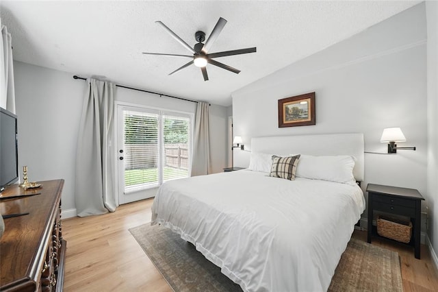 636 Parker Dr, Ballwin, MO 63021 - bedroom featuring light wood-type flooring, access to outside, a ceiling fan, baseboards, and lofted ceiling