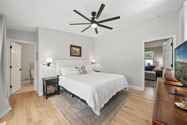636 Parker Dr, Ballwin, MO 63021 - bedroom featuring light wood-type flooring, baseboards, a ceiling fan, and connected bathroom