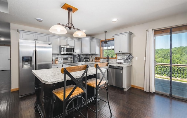 20998 Halifax Dr, Saint Robert, MO 65584 - kitchen with stainless steel appliances, baseboards, light countertops, gray cabinetry, and tasteful backsplash