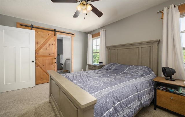 20998 Halifax Dr, Saint Robert, MO 65584 - bedroom with light carpet, a barn door, and a ceiling fan