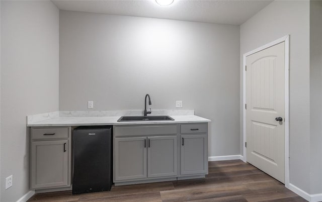 20998 Halifax Dr, Saint Robert, MO 65584 - bar with a sink, dark wood-style floors, black dishwasher, and baseboards