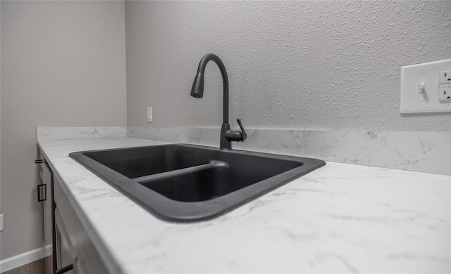 20998 Halifax Dr, Saint Robert, MO 65584 - kitchen view of a sink, light stone counters, and white cabinetry
