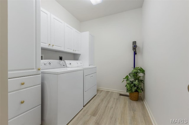 943 Sheffield Forest Ct, Saint Louis, MO 63021 - laundry room featuring cabinet space, washing machine and clothes dryer, and light wood-type flooring