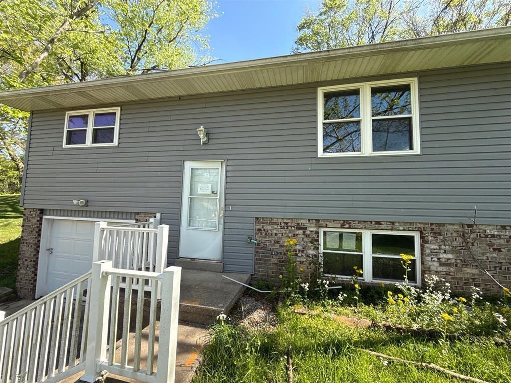 1756 Northwoods Ct, Cape Girardeau, MO 63701 - rear view of house featuring a garage and brick siding