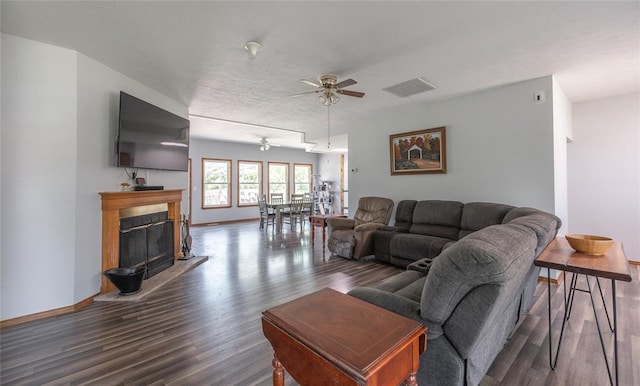 12755 Echo Ln, Plato, MO 65552 - living area featuring ceiling fan, wood finished floors, a fireplace with raised hearth, and baseboards