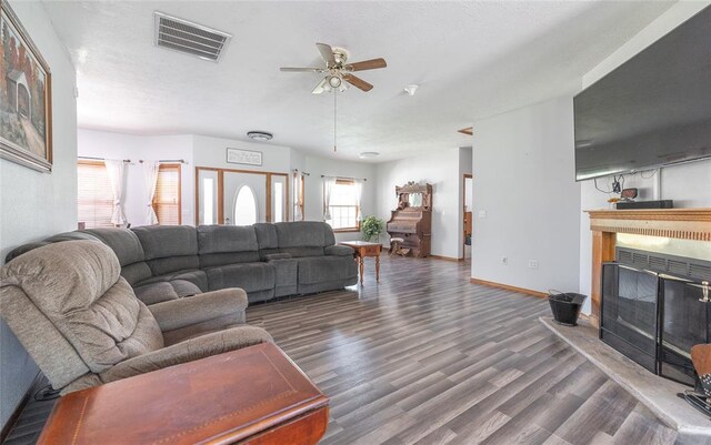 12755 Echo Ln, Plato, MO 65552 - living area with a glass covered fireplace, wood finished floors, a ceiling fan, and baseboards