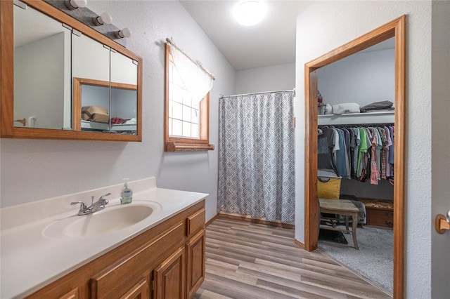 12755 Echo Ln, Plato, MO 65552 - full bathroom featuring vanity, wood finished floors, curtained shower, and a spacious closet