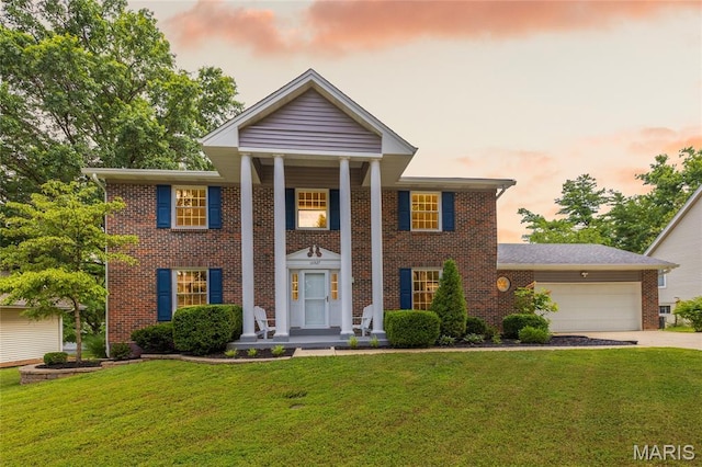 16027 Clarkson Woods Dr, Chesterfield, MO 63017 - neoclassical / greek revival house featuring brick siding, an attached garage, driveway, and a yard