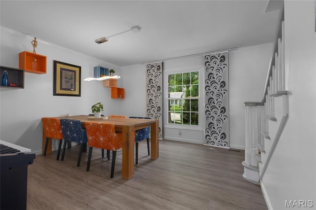 16027 Clarkson Woods Dr, Chesterfield, MO 63017 - dining room featuring wood finished floors, stairs, and crown molding