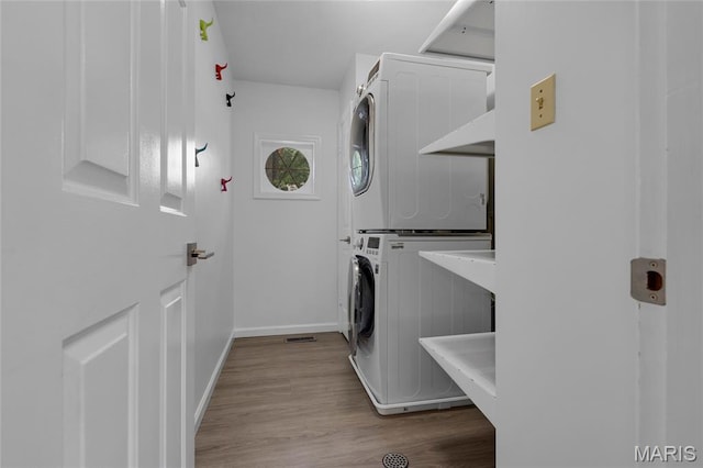 16027 Clarkson Woods Dr, Chesterfield, MO 63017 - laundry area with stacked washer / drying machine and wood finished floors