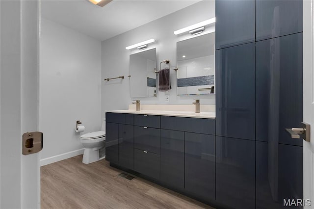 16027 Clarkson Woods Dr, Chesterfield, MO 63017 - bathroom featuring double vanity, wood finished floors, and a shower