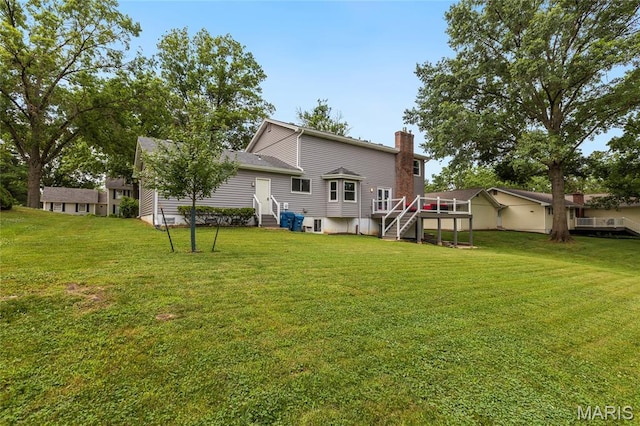 16027 Clarkson Woods Dr, Chesterfield, MO 63017 - rear view of house featuring a chimney, a yard, and entry steps