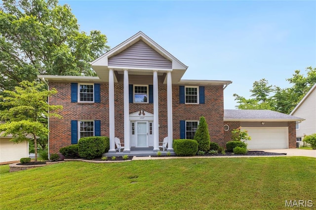 16027 Clarkson Woods Dr, Chesterfield, MO 63017 - greek revival house with a garage, driveway, brick siding, and a front lawn