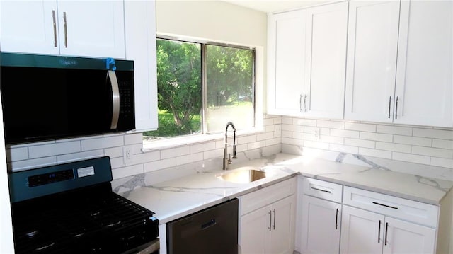 3213 Yvette Ct, Florissant, MO 63031 - kitchen with appliances with stainless steel finishes, a sink, white cabinetry, and decorative backsplash