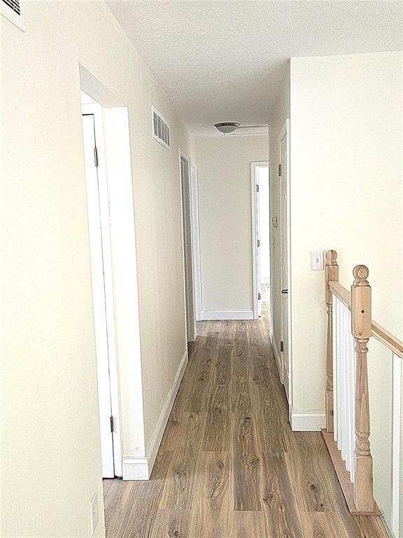 3213 Yvette Ct, Florissant, MO 63031 - hall featuring wood finished floors, an upstairs landing, and baseboards