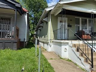 5955 Harney, Saint Louis, MO 63135 - view of home's exterior with covered porch and a yard