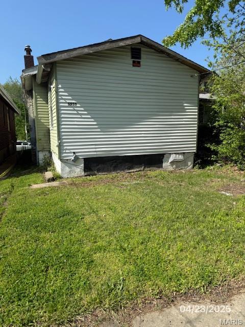 5955 Harney, Saint Louis, MO 63135 - view of property exterior with a lawn and a chimney