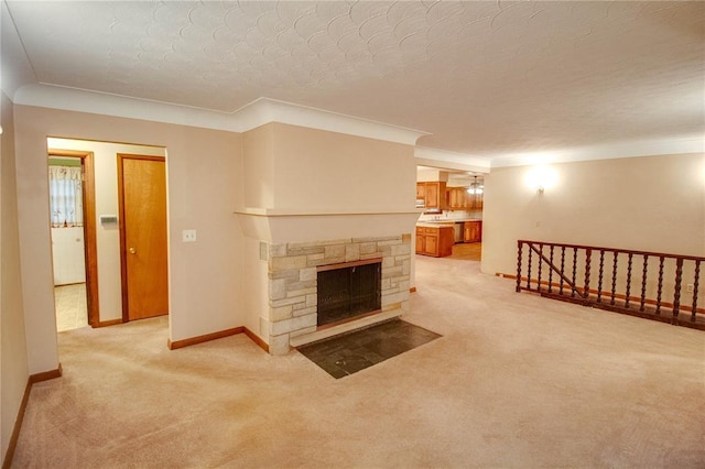 3406 Mcarthur Blvd, Alton, IL 62002 - unfurnished living room featuring light colored carpet, a textured ceiling, ornamental molding, baseboards, and a stone fireplace