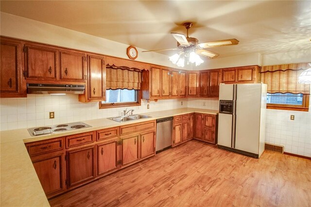 3406 Mcarthur Blvd, Alton, IL 62002 - kitchen featuring white appliances, under cabinet range hood, a sink, and brown cabinets