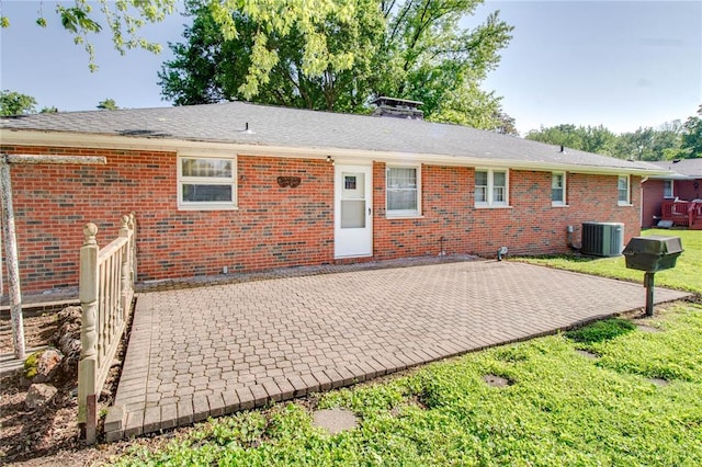 3406 Mcarthur Blvd, Alton, IL 62002 - back of property with cooling unit, a patio, brick siding, and a lawn