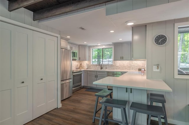 600 Innisfree Lake Dr, Innsbrook, MO 63390 - kitchen with stainless steel appliances, backsplash, a peninsula, plenty of natural light, and beam ceiling