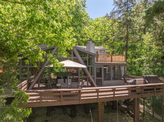 600 Innisfree Lake Dr, Innsbrook, MO 63390 - back of property featuring a wooden deck, a chimney, and a sunroom