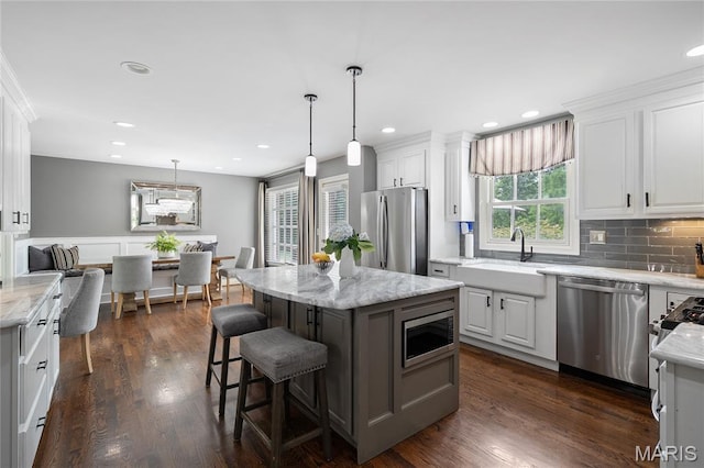 9800 Countryshire Pl, Creve Coeur, MO 63141 - kitchen featuring appliances with stainless steel finishes, white cabinetry, decorative backsplash, pendant lighting, and recessed lighting