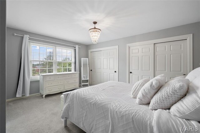 9800 Countryshire Pl, Creve Coeur, MO 63141 - carpeted bedroom with multiple closets and a chandelier