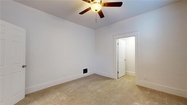 unfurnished room featuring light carpet, baseboards, and ceiling fan