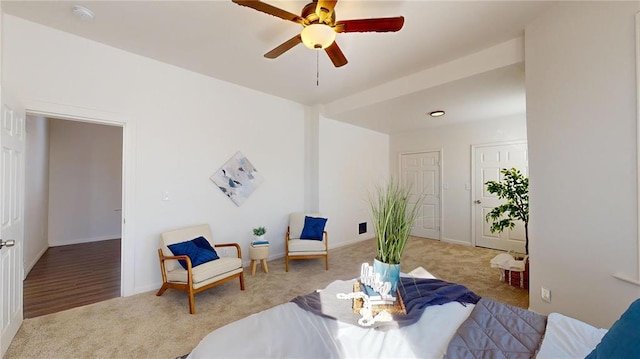 living area with carpet, ceiling fan, and baseboards