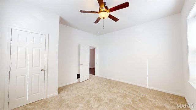 2111 W Main St, Belleville, IL 62226 - unfurnished bedroom featuring light carpet, baseboards, and ceiling fan