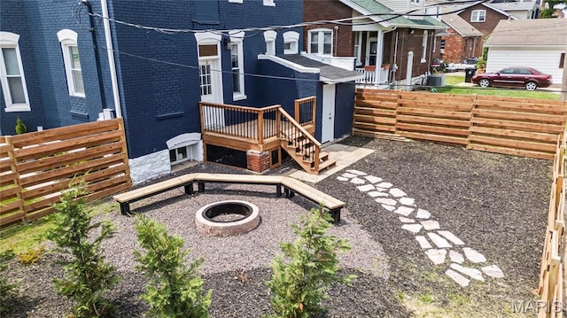 2111 W Main St, Belleville, IL 62226 - fenced backyard with a fire pit and a wooden deck